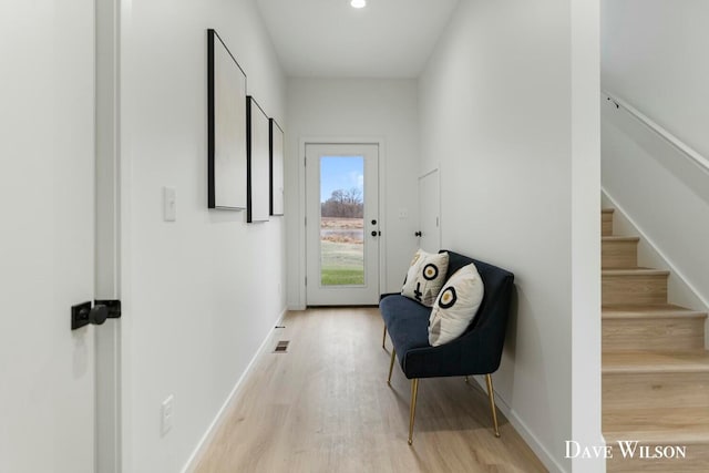 hallway with light hardwood / wood-style floors