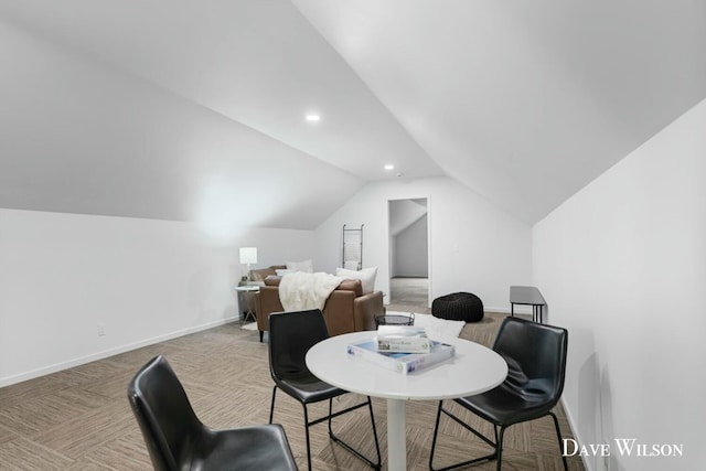 dining space featuring carpet floors and vaulted ceiling