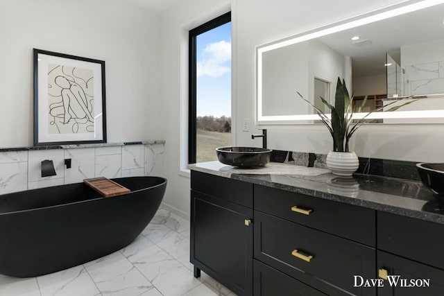 bathroom with vanity and a tub