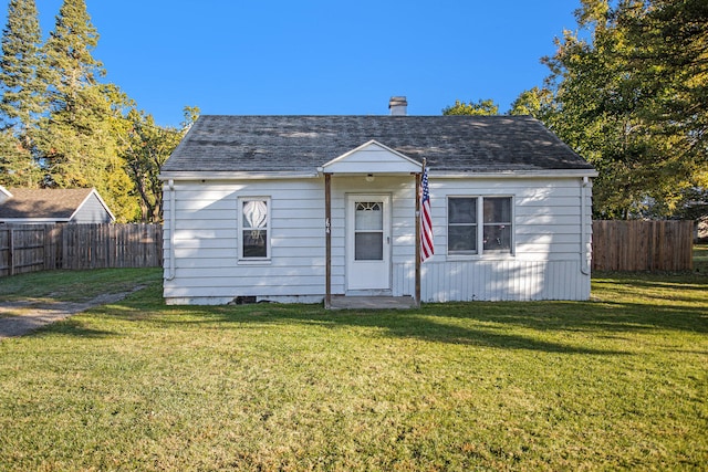 bungalow-style house with a front yard