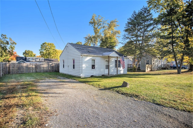 bungalow-style home with a front yard