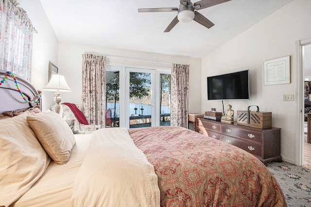 carpeted bedroom with ceiling fan, access to outside, and vaulted ceiling