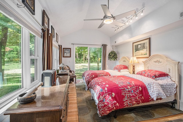 bedroom featuring ceiling fan, access to outside, lofted ceiling, and dark hardwood / wood-style floors