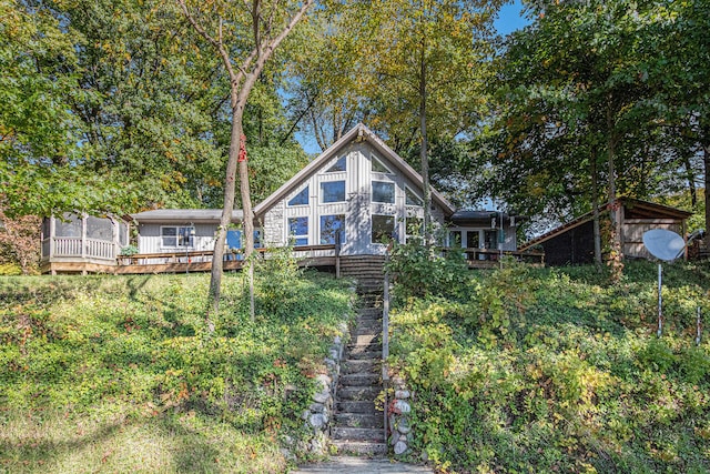 rear view of house featuring a deck