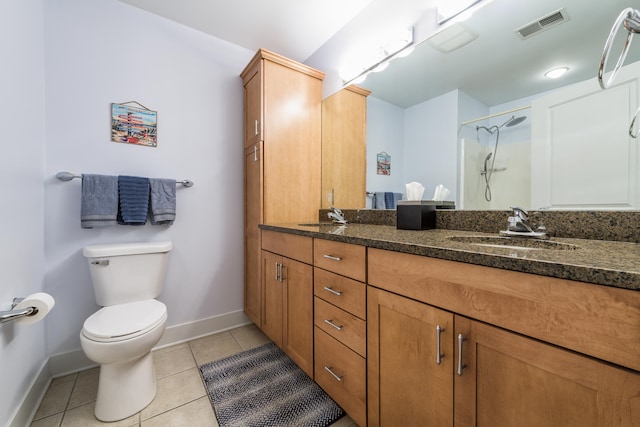 bathroom with vanity, toilet, walk in shower, and tile patterned flooring