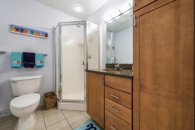 bathroom with a shower with door, toilet, tile patterned floors, and vanity