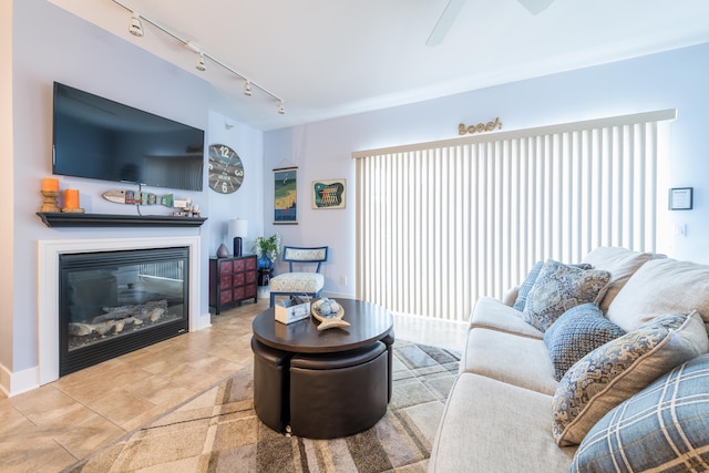 living room featuring rail lighting, tile patterned flooring, and ceiling fan