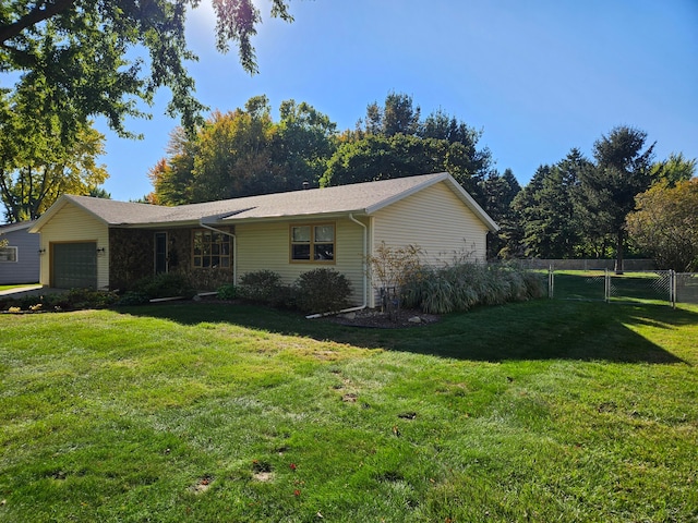 view of property exterior featuring a garage and a lawn