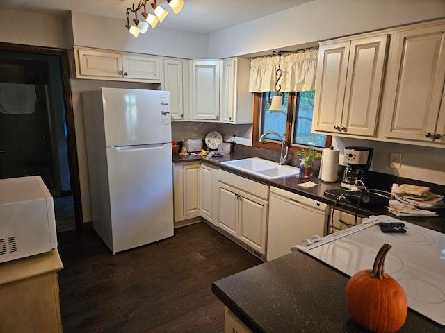 kitchen with dark wood-type flooring, sink, and white appliances