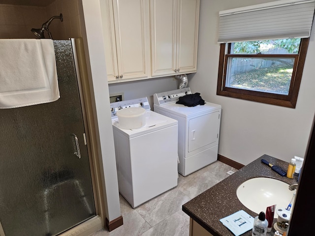 laundry area with washing machine and dryer, sink, and light tile patterned floors