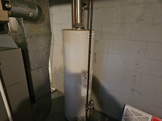 utility room featuring gas water heater and heating unit