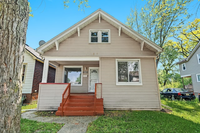 bungalow-style home featuring a front yard