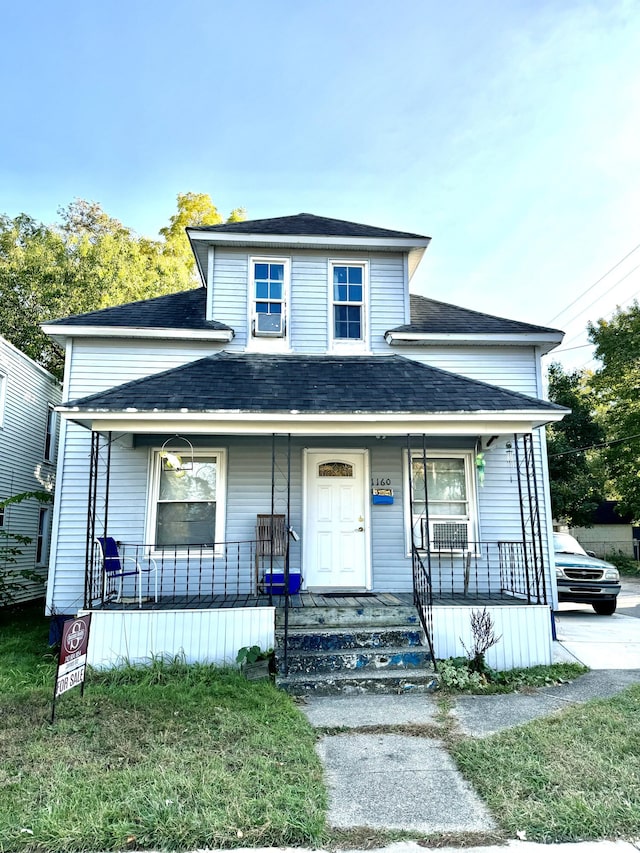 view of front facade with covered porch and a front lawn