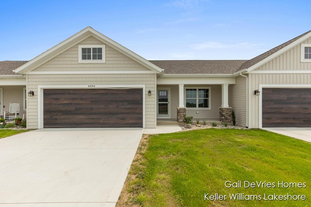 4494 Meadow Pond Way Unit 68, Hamilton, MI 49419 - craftsman house with an attached garage, concrete driveway, a front lawn, board and batten siding, and roof with shingles