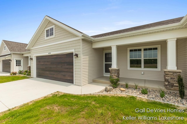 4494 Meadow Pond Way Unit 68, Hamilton, MI 49419 - craftsman house featuring concrete driveway, an attached garage, covered porch, and roof with shingles