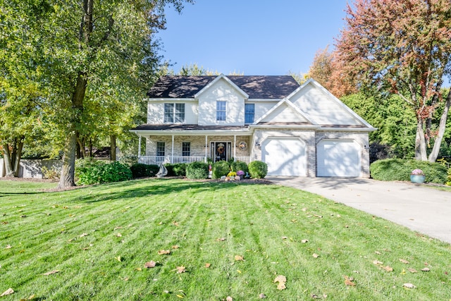 view of front of home featuring a porch, a front lawn, and a garage