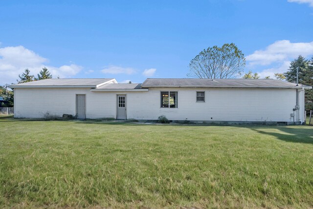 rear view of house with a lawn