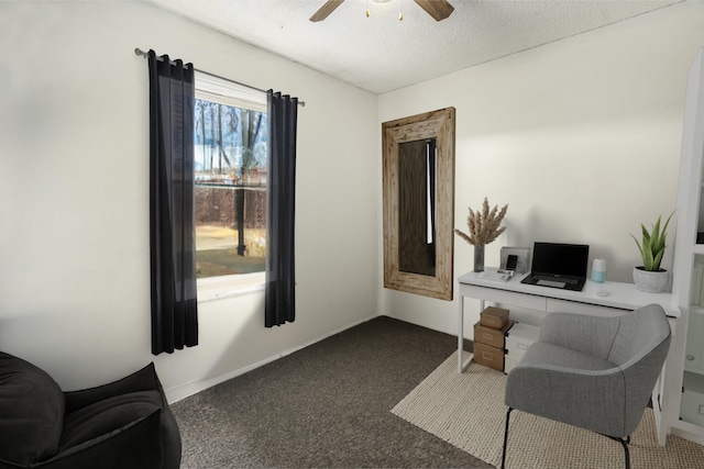 home office with ceiling fan, carpet, and a textured ceiling