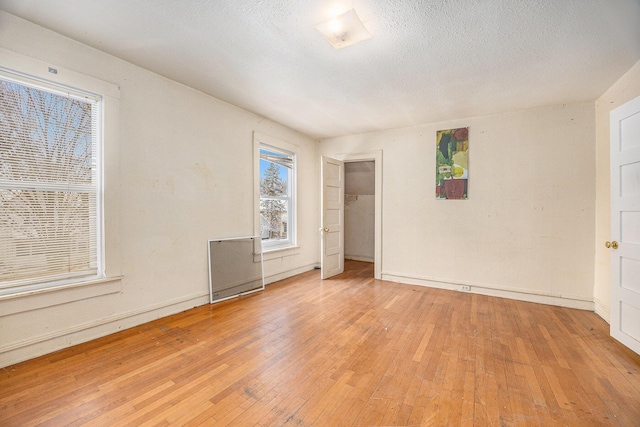 interior space featuring light hardwood / wood-style floors and a textured ceiling