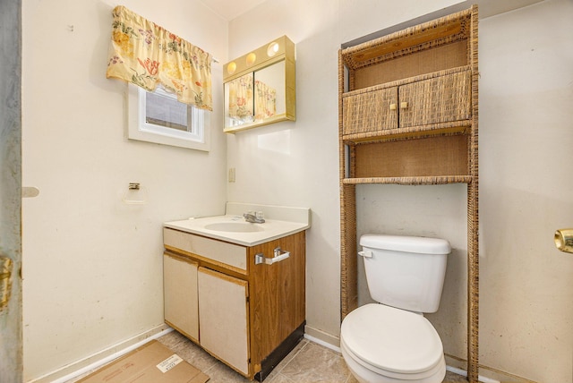 bathroom featuring tile patterned flooring, vanity, and toilet