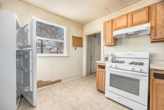 kitchen featuring white range with gas cooktop