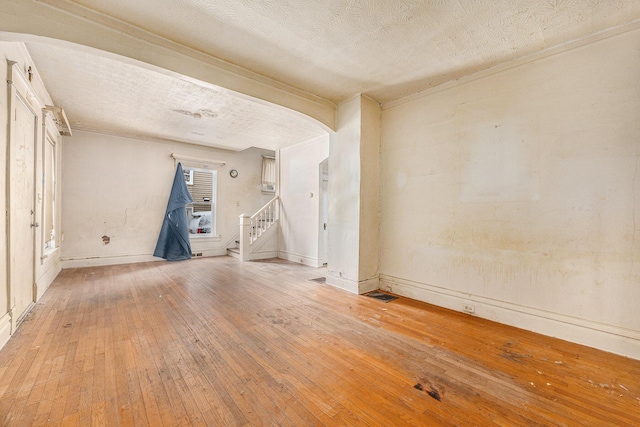 empty room featuring a textured ceiling and light wood-type flooring