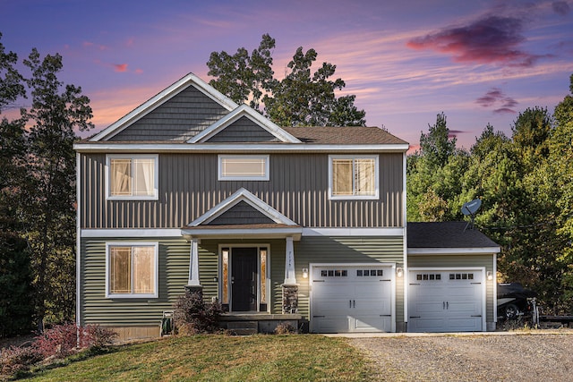 view of front of home with a yard and a garage