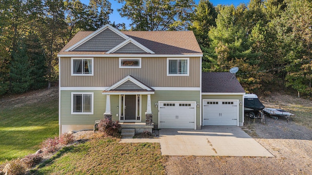 craftsman-style home featuring a front yard and a garage