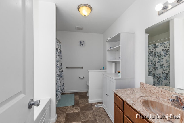 full bathroom featuring vanity, shower with separate bathtub, and toilet