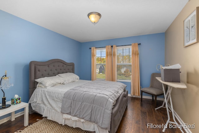 bedroom with dark hardwood / wood-style floors