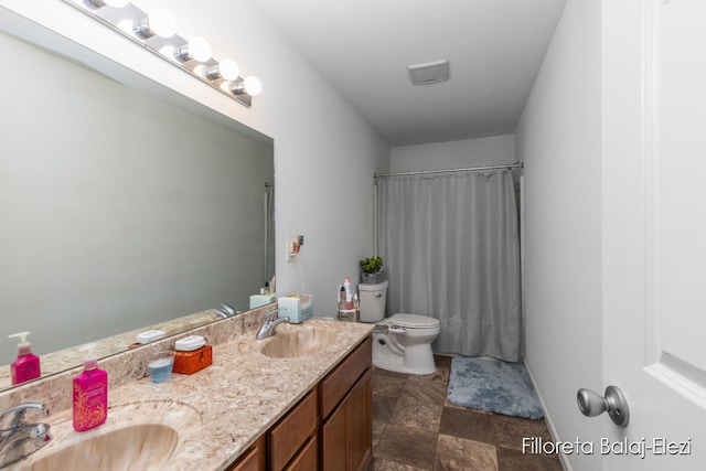 bathroom with vanity, a shower with shower curtain, and toilet