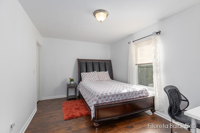 bedroom with dark hardwood / wood-style floors