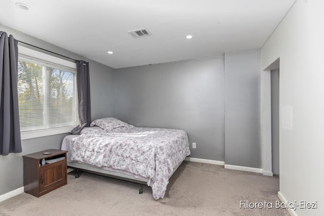 bedroom with light colored carpet