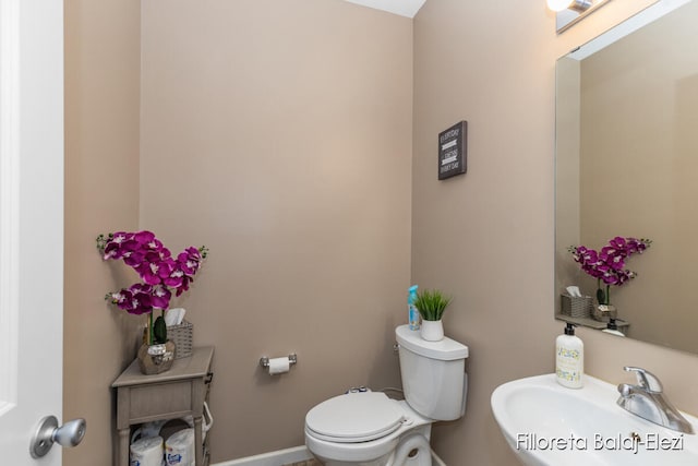 bathroom featuring toilet and sink