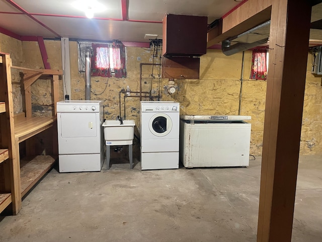 basement featuring sink and washing machine and dryer