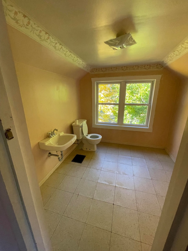 bathroom with toilet, tile patterned floors, and sink