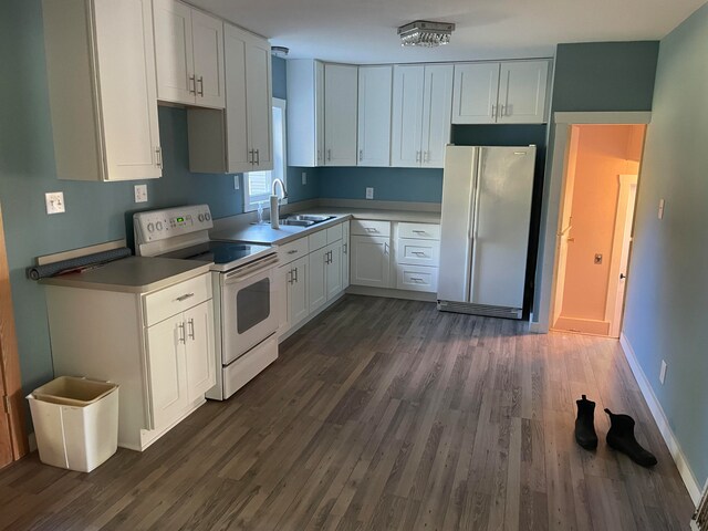 kitchen featuring white appliances, white cabinetry, sink, and dark hardwood / wood-style floors