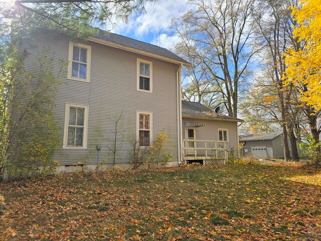 view of home's exterior with a yard, an outbuilding, and a garage