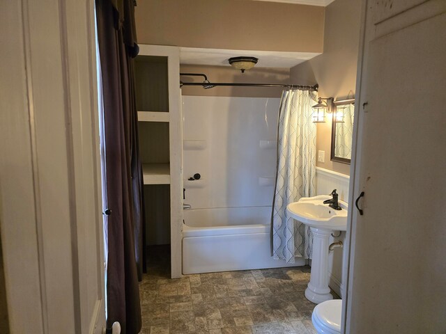 bathroom with toilet and shower / bath combo with shower curtain