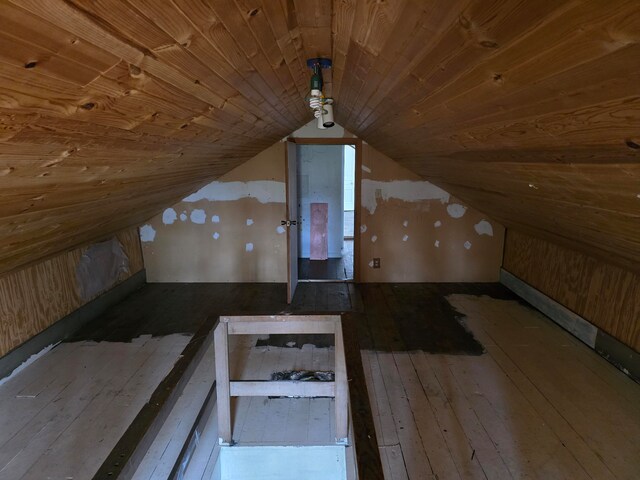 bonus room featuring vaulted ceiling, hardwood / wood-style flooring, and wooden ceiling