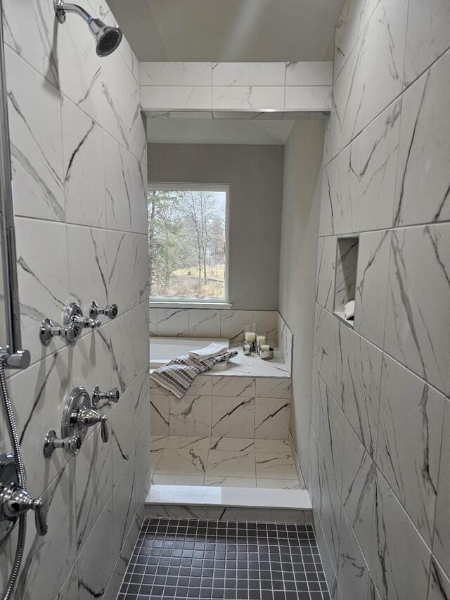 bathroom with tile patterned flooring and tiled shower