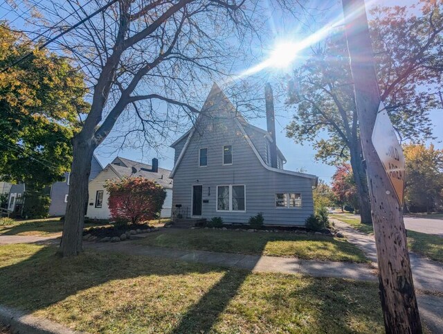 view of property exterior with a lawn