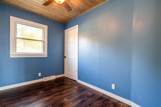 unfurnished room with crown molding, dark hardwood / wood-style floors, wooden ceiling, and ceiling fan