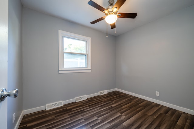 empty room featuring ceiling fan and dark hardwood / wood-style flooring