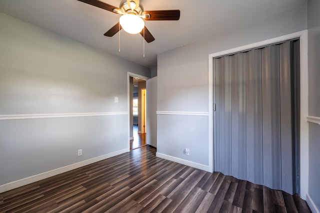 unfurnished bedroom with ceiling fan, a closet, and dark hardwood / wood-style flooring