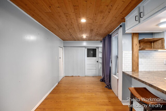 hall with wooden ceiling and light wood-type flooring