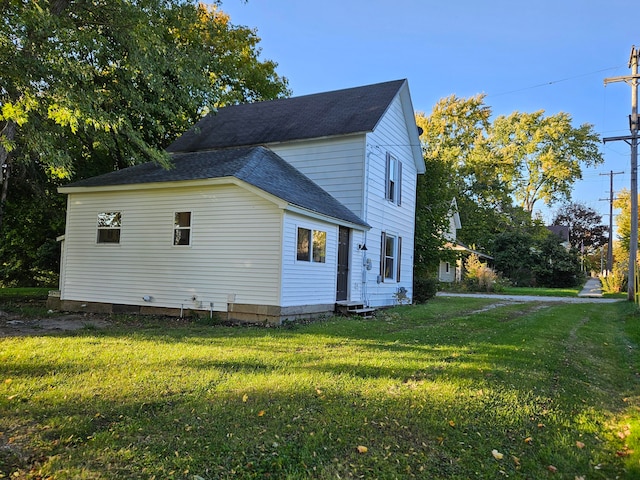 view of home's exterior with a yard