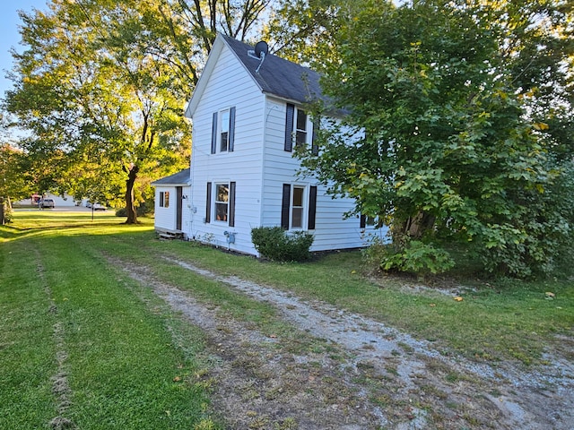 view of side of home featuring a yard