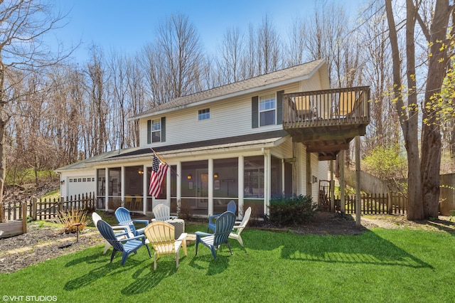 rear view of house featuring a yard and a sunroom