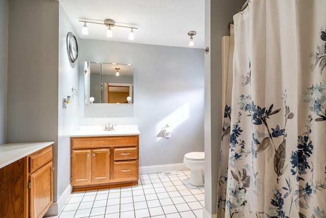 bathroom featuring vanity, toilet, and tile patterned floors